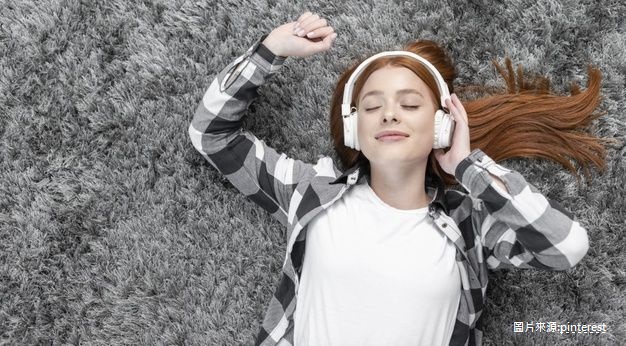 woman enjoying music top view